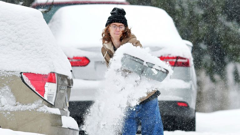 Pennsylvania resident Elijah Minahan shovels out the driveway of his home. Pic: AP