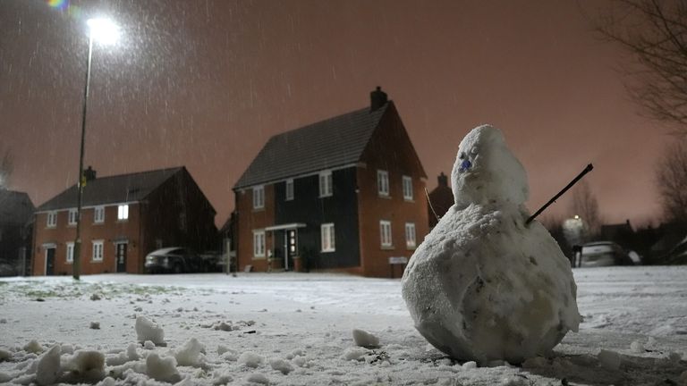 It's not all doom and gloom - someone's made a snowman in Basingstoke, Hampshire. Pic: PA