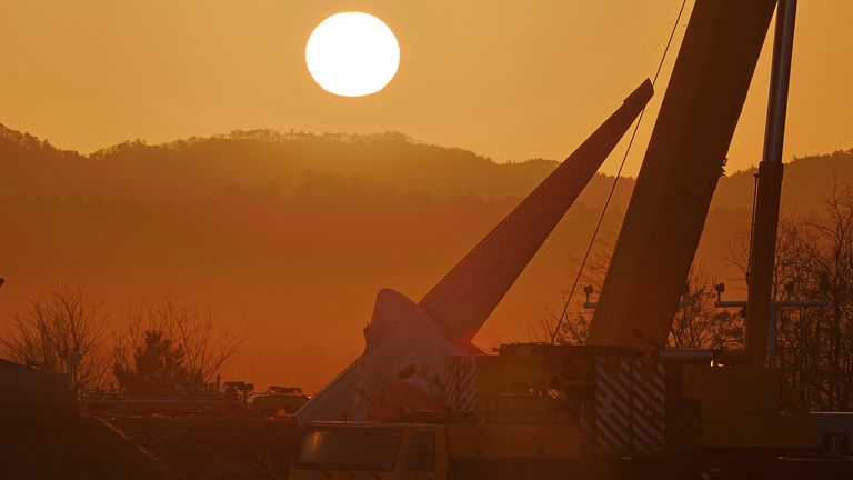 The first sunrise on New Year's day is seen near the site of a plane crash at Muan International Airport in Muan, South Korea, Wednesday, Jan. 1, 2025. (Son Hyung-ju/Yonhap via AP)