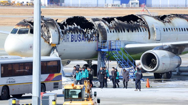 Mayor of Busan Park Heong-joon and other officials visit the site where an Air Busan airplane caught fire at Gimhae International Airport in Busan, South Korea, Wednesday, Jan. 29, 2025. (Son Hyung-joo/Yonhap via AP)