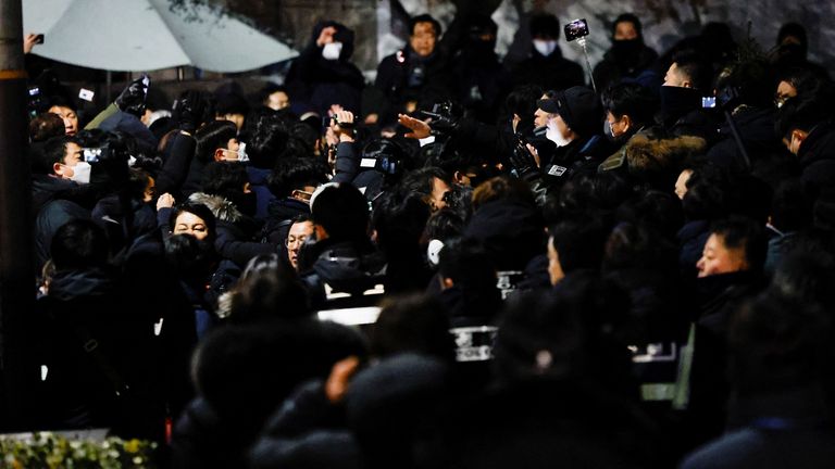 Police officers and members of the Corruption Investigation Office for High-ranking Officials gather near the official residence of the impeached South Korean President Yoon Suk Yeol, as authorities are seeking to execute an arrest warrant, in Seoul, South Korea, January 15, 2025. REUTERS/Tyrone Siu