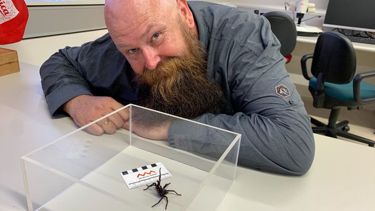 Mr Christensen poses with the spider named after him. Pic: Reuters