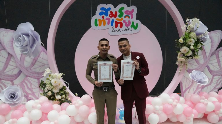 Pisit Sirihirunchai, left, and Chanatip Sirihirunchai show their marriage certificates. Pic AP