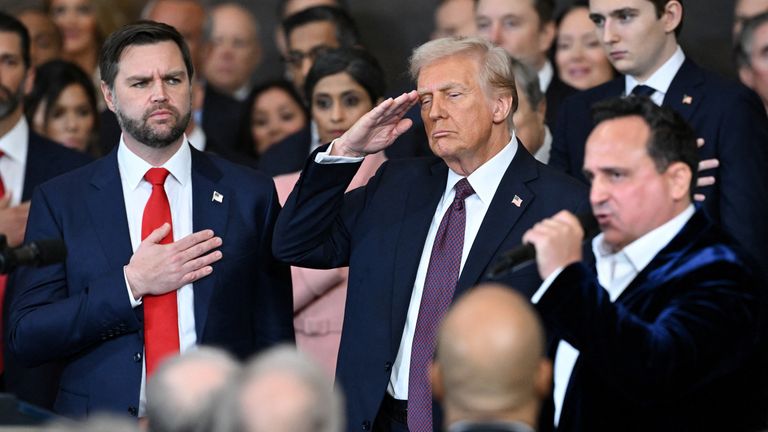 Donald Trump salutes as Christopher Macchio performs the Star-Spangled Banner. Photo: Reuters