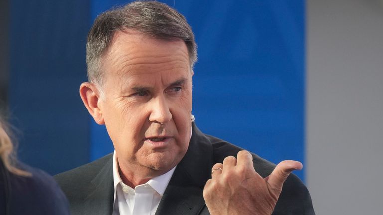 Television presenter Tony Jones during a live cross at Melbourne Park venue for the Australian Open tennis championship in Melbourne, Australia, Monday, Jan. 20, 2025. (AP Photo/Mark Baker)