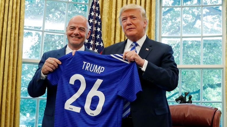 U.S. President Donald Trump poses with the President of FIFA Gianni Infantino with a gift jersey from Infantino in the Oval Office at the White House in Washington, D.C., U.S. August 28, 2018. REUTERS/Leah Millis