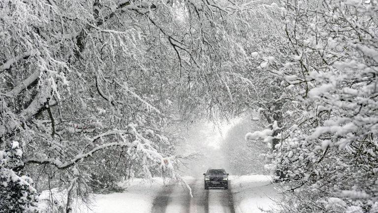 A vehicle is driven along a snow-covered road in Scotton, Harrogate, North Yorkshire. Pic: PA