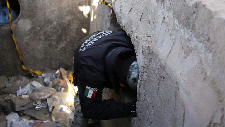 A member of the Mexican National Guard enters an illegal tunnel between the US and Mexico. Pic: Reuters