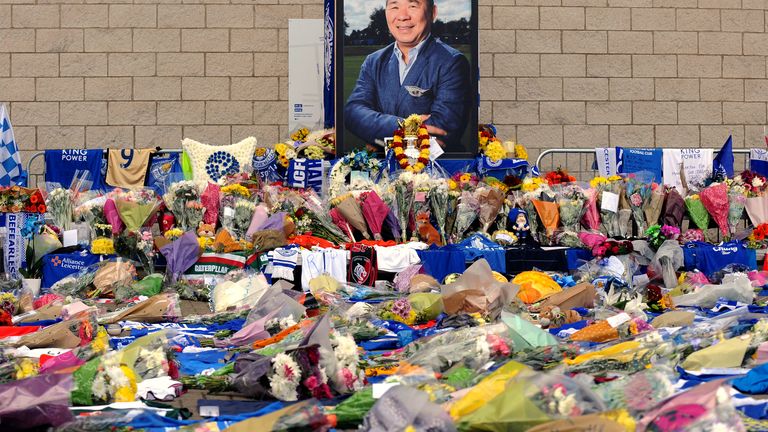 FILE - Tributes from supporters rest at a memorial under a portrait of team owner Vichai Srivaddhanaprabha outside Leicester City Football Club, Monday Oct. 29 2018, in Leicester, England. . (AP Photo/Rui Vieira, File)