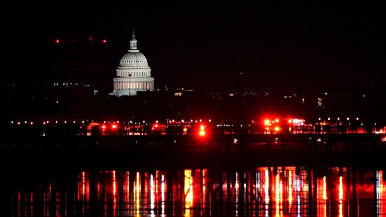 Emergency responders at the crash site with the U.S. Capitol visible in the background, following the collision of American Eagle flight 5342 with a Black Hawk helicopter as it approached Ronald Reagan Washington National Airport, crashing into the Potomac River, U.S., January 30, 2025. REUTERS/Nathan Howard TPX IMAGES OF THE DAY