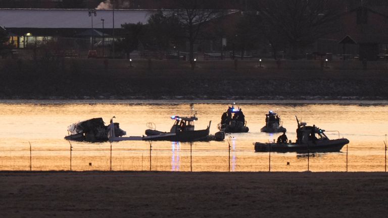 Search and rescue efforts are seen around a wreckage site in the Potomac River from Ronald Reagan Washington National Airport, early Thursday morning, Jan. 30, 2025, in Arlington, Va. (AP Photo/Mark Schiefelbein)