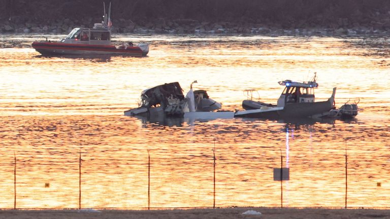 Emergency personnel work at the site of the crash after a Black Hawk helicopter and an American Eagle flight 5342 approaching Reagan Washington National Airport collided and crashed in the Potomac River, outside Washington, U.S., January 30, 2025. REUTERS/Kevin Lamarque