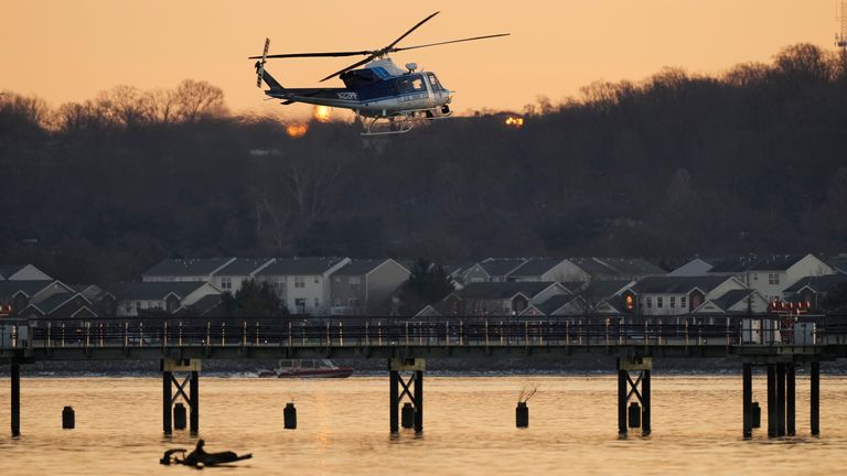 A US Park Police helicopter flies over the Potomac River near Ronald Reagan Washington National Airport, Thursday, Jan. 30, 2025, in Arlington, Va. (AP Photo/Carolyn Kaster)