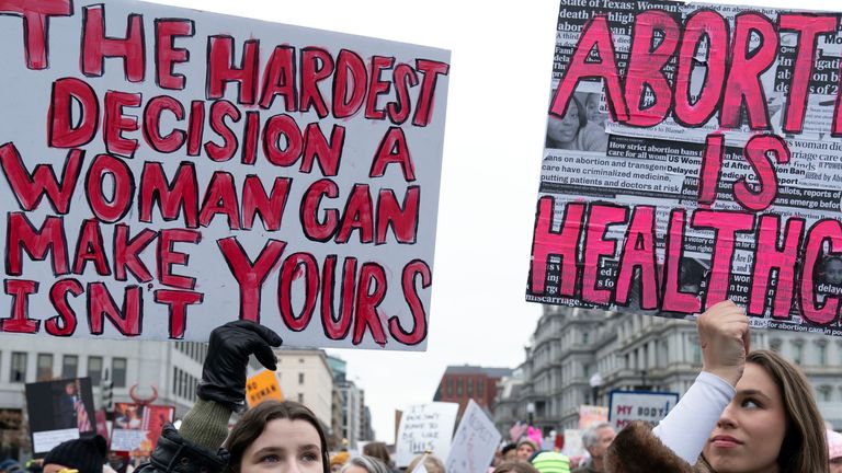 Demonstrators protest President-elect Donald Trump's incoming administration during the People's March, Saturday, Jan. 18, 2025, in Washington. (AP Photo/Jose Luis Magana)