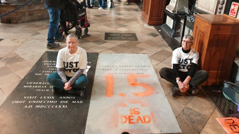 Just Stop Oil protesters Di Bligh and Alyson Lee after spray painting ''1.5 is dead'' on Charles Darwin’s grave in Westminster Abbey.
Pic: Just Stop Oil/PA