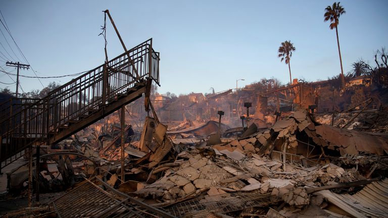 A staircase is left partially standing in a property in the aftermath of the Palisades Fire in the Pacific Palisades neighborhood of Los Angeles, Friday, Jan. 10, 2025. (AP Photo/John Locher)