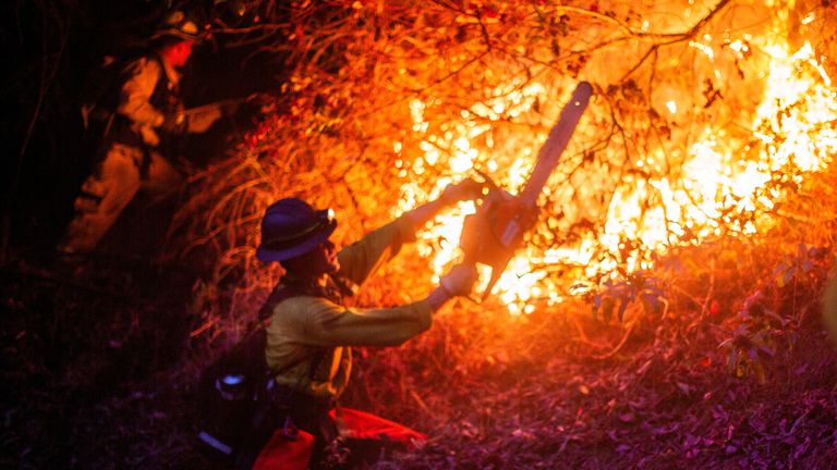 A firefighter combating the Pacific Palisades fire. Pic: Reuters