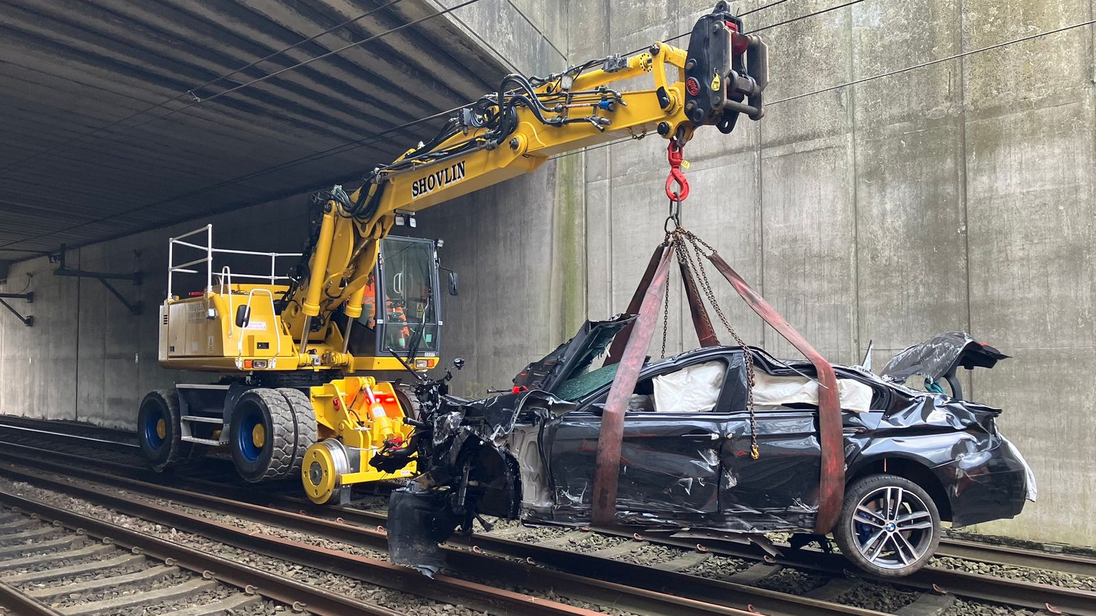 Car Crashes From Bridge Onto Rail Line Causing Travel Disruption