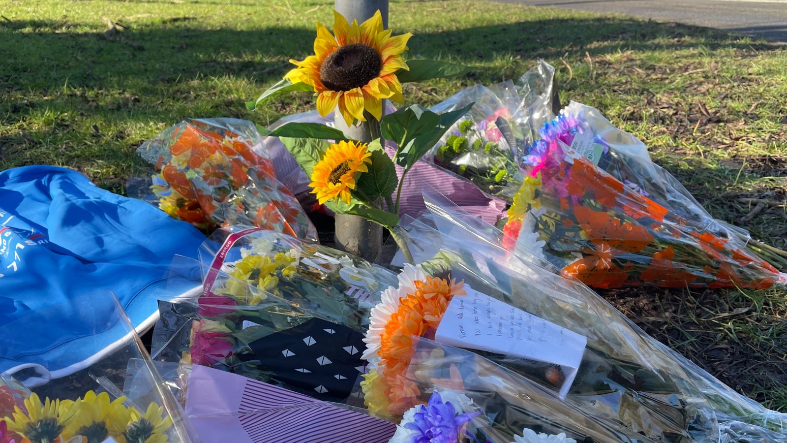 Flowers left at scene as community pays tribute to two children killed in hit-and-run crash