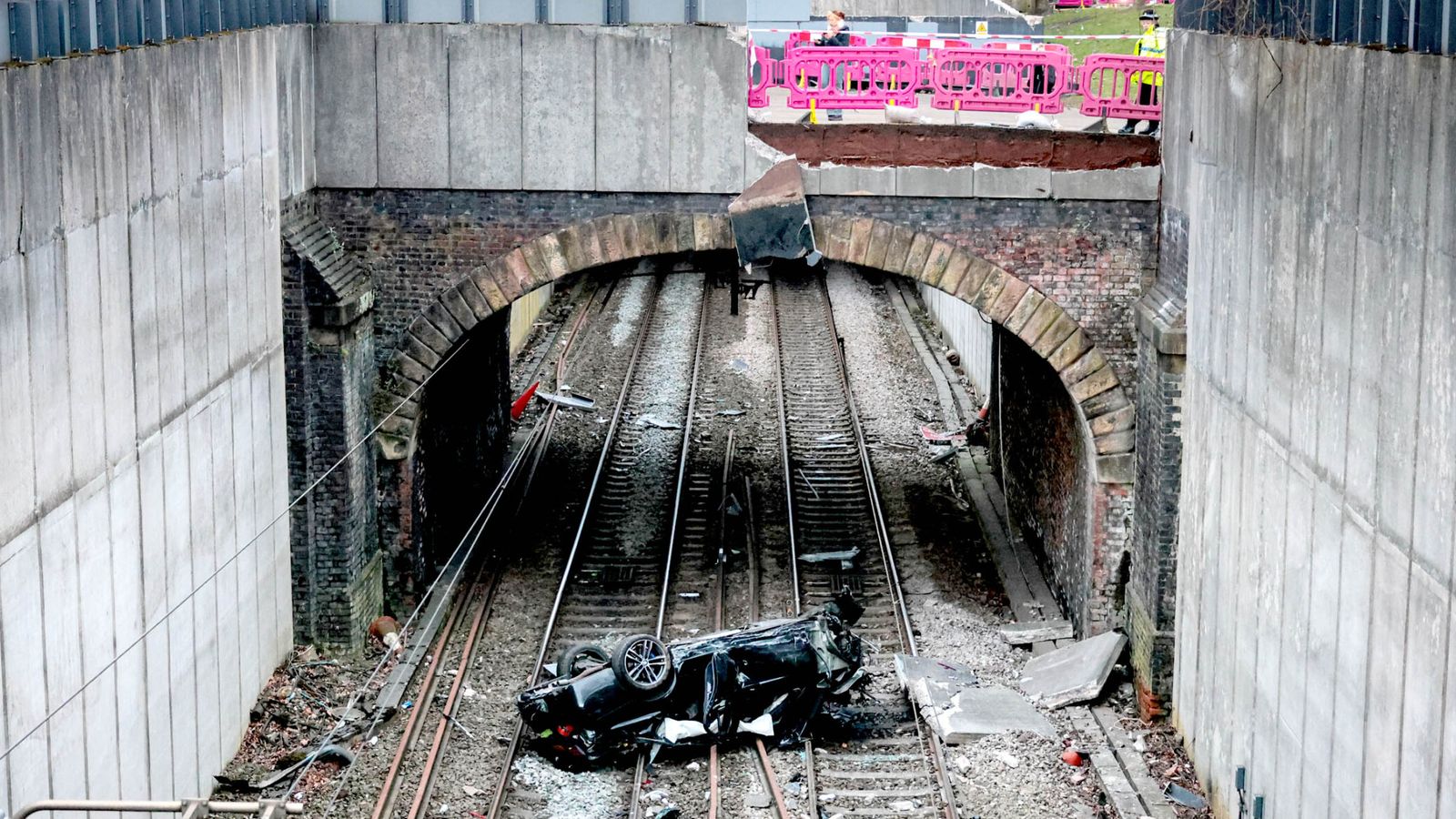 Major travel disruption in Manchester after car crashes onto railway lines – driver arrested