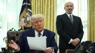 President Donald Trump in the Oval Office at the White House where he signed an executive order in Washington, on Feb. 13, 2025. At right is Commerce Secretary Howard Lutnick. (Francis Chung/POLITICO via AP Images)
