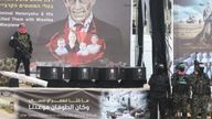 A Hamas militant stands on stage near coffins during the handover of deceased hostages Oded Lifschitz, Shiri Bibas and her two children Kfir and Ariel Bibas, seized during the deadly October 7, 2023 attack, to the Red Cross, as part of a ceasefire and hostages-prisoners swap deal between Hamas and Israel, in Khan Younis in the southern Gaza Strip, February 20, 2025. REUTERS/Ramadan Abed
