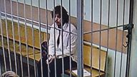 Kalob Wayne Byers, detained on suspicion of drug smuggling, appears on a screen in a courthouse in Moscow.
Pic: Reuters/Moscow City Court's Press Office