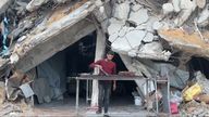 Man cooking amid rubble