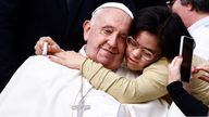 Pope Francis is hugged as he attends the weekly general audience in St. Peter's Square at the Vatican, October 9, 2024. REUTERS/Yara Nardi