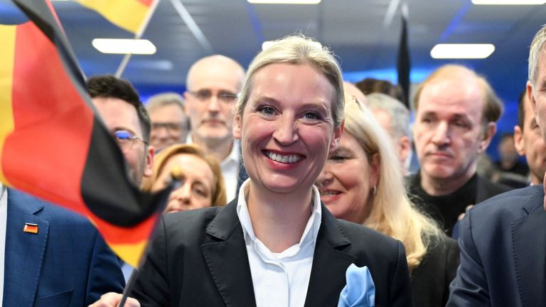 23 February 2025, Berlin: Alice Weidel, federal chairman and candidate for chancellor of the AfD, waves a German flag at the AFD election party at the AfD federal office. On the left is Tino Chrupalla, national chairman of the AfD, and on the right is Bj'rn H'cke (AfD). The early election to the 21st German Bundestag took place on Sunday. Photo by: S'ren Stache/picture-alliance/dpa/AP Images