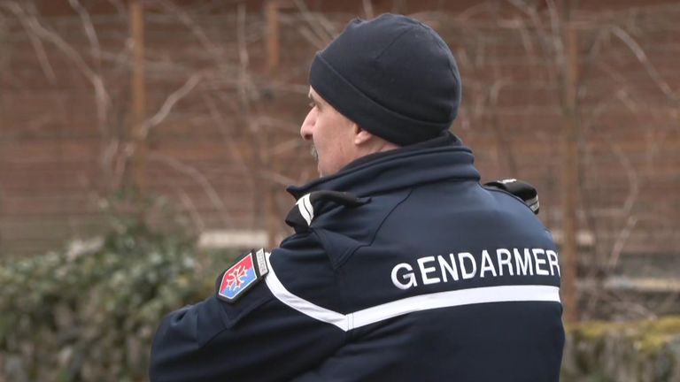 A police officer outside Andrew and Dawn Searle's home in France