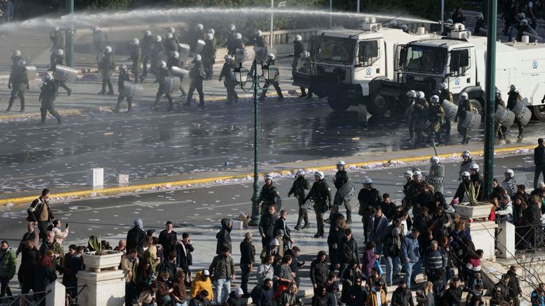 Police water canons operate against protesters during clashes after a massive rally in central Athens, Greece to mark two years since a deadly rail disaster that has also triggered hundreds of other demonstrations and a general strike, on Friday, Feb. 28, 2025. (AP Photo/Thanassis Stavrakis)