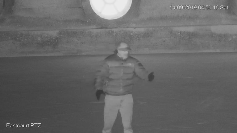 Screen grab taken from CCTV dated 14/09/19 issued by Thames Valley Police showing a man stood in the courtyard at the front of Blenheim Palace, as thieves rolled a £4.75 million gold toilet away and bundled it into the back of a car after stealing it in an early morning raid. The video has been shown in court at the trial of Michael Jones, who is accused of burglary, and Frederick Sines and Bora Guccuk who are each charged with one count of conspiracy to transfer criminal property. Issue date: T