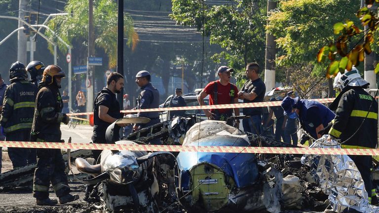 Emergency personnel work at the site where a small plane crashed into vehicles on Marques de Sao Vicente Avenue in Sao Paulo, Brazil.
Pic: Reuters