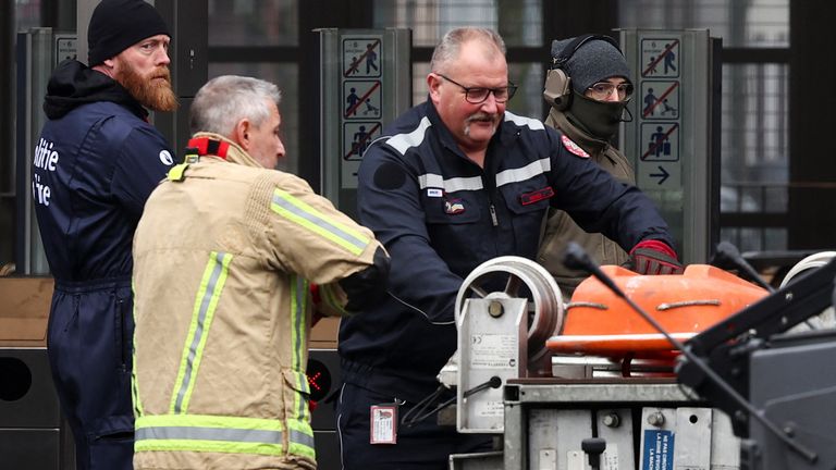 Firefighters work at the Clemenceau metro station, after a shooting took place in Brussels.
Pic: Reuters