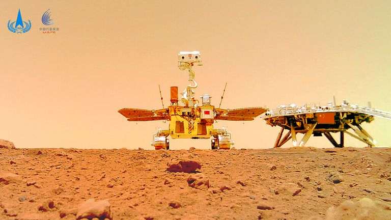 FOR USE WITH STORY CHINA MARS PHOTOS In this image released by the China National Space Administration (CNSA) on Friday, June 11, 2021, the Chinese Mars rover Zhurong is seen near its landing platform taken by a remote camera that was dropped into position by the rover.  China on Friday released a series of photos taken by its Zhurong rover on the surface of Mars, including one of the rover itself taken by a remote camera. (CNSA via AP)