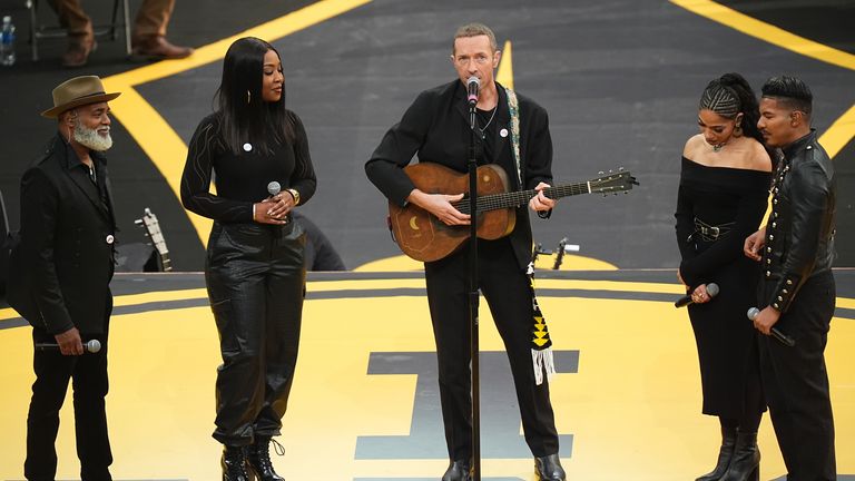 Chris Martin with members of the Universal Gospel Choir perform at the opening ceremony. Pic: PA