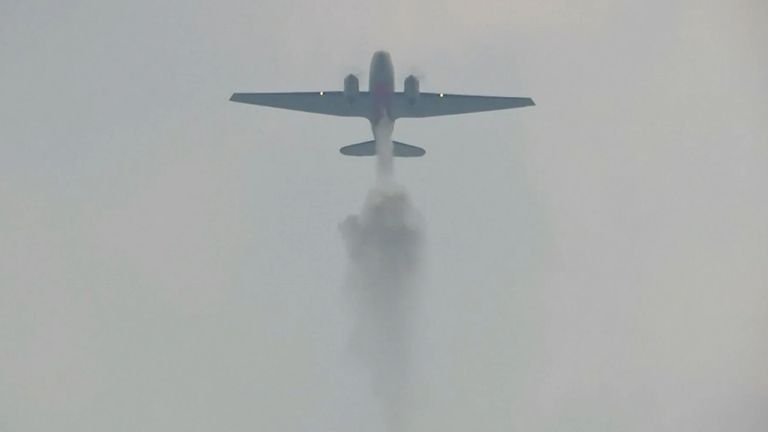 The 'rainmaker' plane dumping water over parts of polluted Thailand.