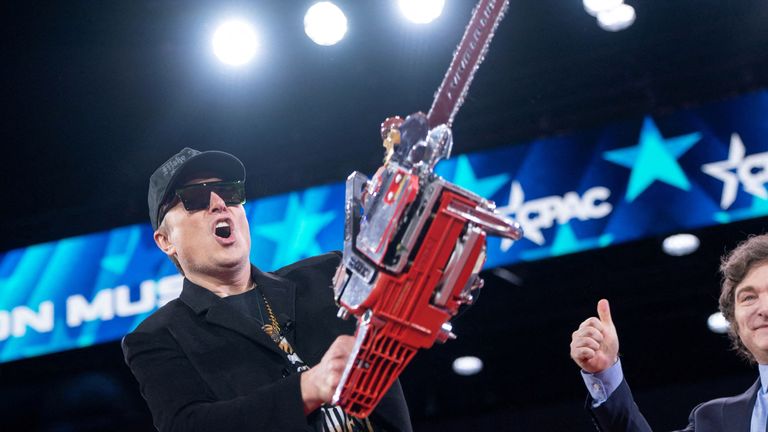 Elon Musk holds a chainsaw gifted by Argentina  president Javier Milei during the Conservative Political Action Conference.  Pic: Reuters