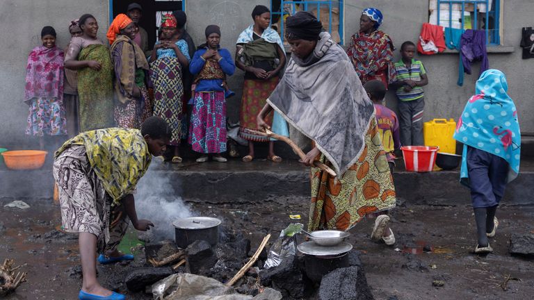 Magdalena Serubungo,55, a displaced mother, cooks lunch at the school where she is taking refuge with her family after their camp in Kanyaruchinya was destroyed, after the town of Goma was taken by the M23 rebels, in Kanyaruchinya, Democratic Republic of Congo, February 8, 2025. REUTERS/Arlette Bashizi
