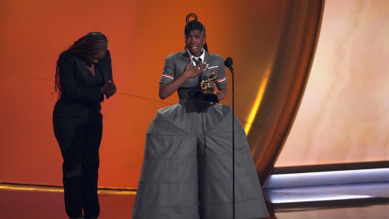 Doechii, center, accepts the award for best rap album for &#34;Alligator Bites Never Heal&#34; during the 67th annual Grammy Awards on Sunday, Feb. 2, 2025, in Los Angeles. Celesia Moore looks on from left(AP Photo/Chris Pizzello)