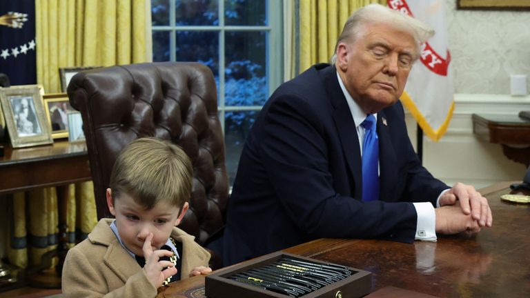 U.S. President Donald Trump looks on as X Æ A-12, Elon Musk's son, scratches his nose in the Oval Office of the White House in Washington, D.C., U.S., February 11, 2025. REUTERS/Kevin Lamarque