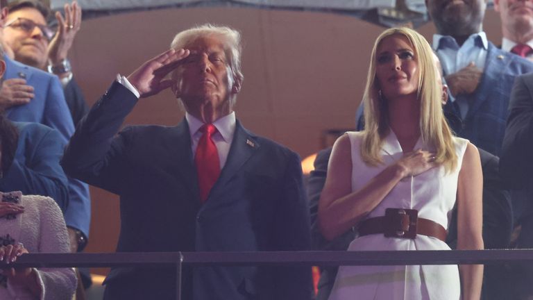 President Trump, alongside his daughter Ivanka, was pictured saluting during the national anthem. Pic: Reuters