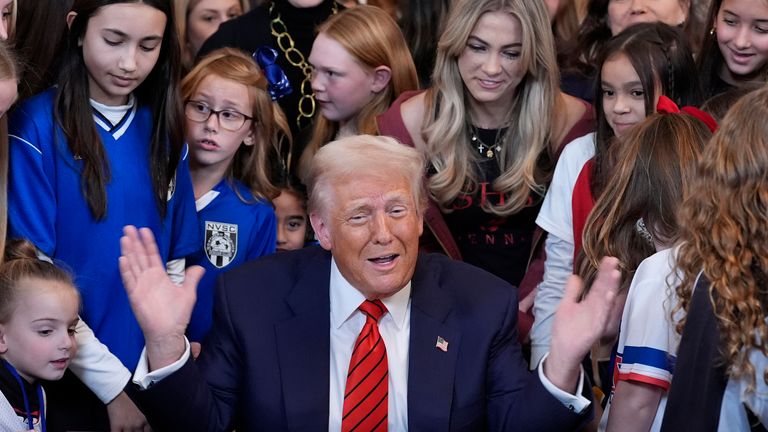 President Donald Trump signs an executive order barring transgender female athletes from competing in women's or girls' sporting events, in the East Room of the White House, Wednesday, Feb. 5, 2025, in Washington. (AP Photo/Alex Brandon)