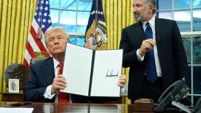 President Donald Trump displays a signed proclamation regarding steel imports as he speaks in the Oval Office at the White House, Monday, Feb. 10, 2025, in Washington, as Commerce Secretary nominee Howard Lutnick watches. (Photo/Alex Brandon)