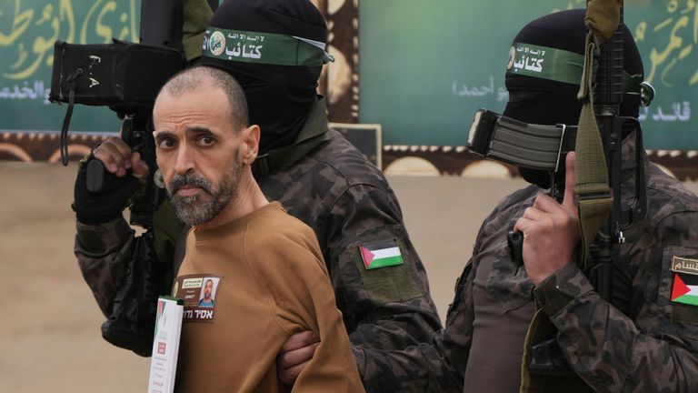 Israeli prisoner Eli Sharabi is accompanied by Hamas fighters before he is handed over to the Red Cross. Pic: ap