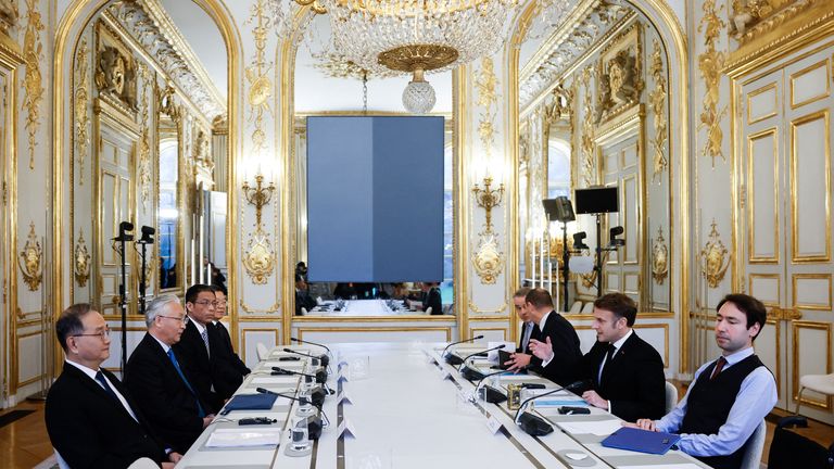 Emmanuel Macron and Chinese Vice Premier Zhang Guoqing sit during their meeting at Elysee Palace in Paris.
Pic: Reuters