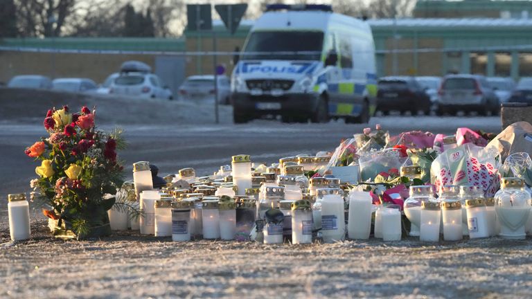 Flowers and candles were left at a makeshift memorial near the scene of the shooting.  Pic: AP