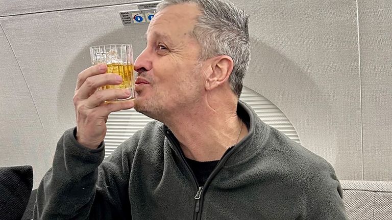 Mr Fogel was pictured enjoying a drink on the flight home. Pic: Reuters