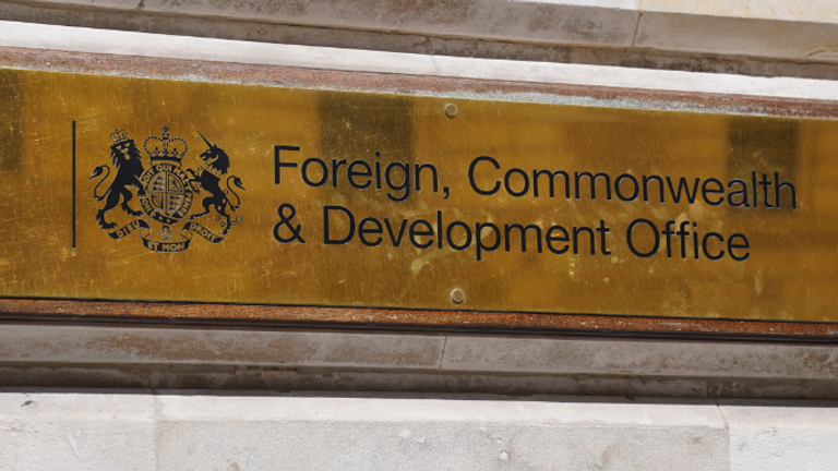 arafed sign on a building with a clock and a building in the background